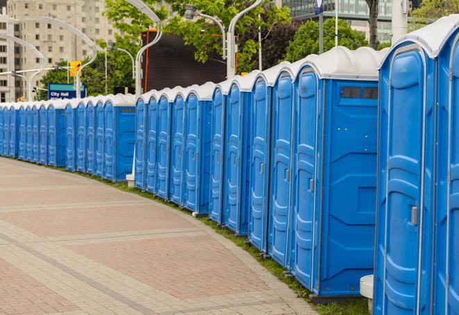 a row of portable restrooms set up for a large athletic event, allowing participants and spectators to easily take care of their needs in Alameda